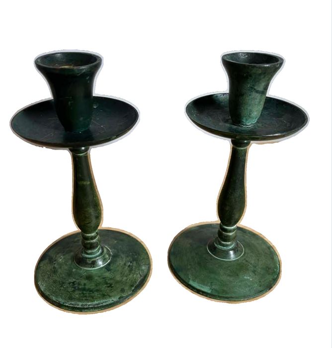 Vintage pair of brass candlestick holders featuring a striking green verdigris patina
